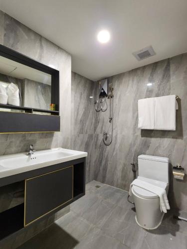 a bathroom with a white toilet and a sink at iCheck inn Darisa Patong in Patong Beach