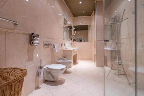 a bathroom with a toilet and a sink and a shower at Residence Seven Angels in Prague