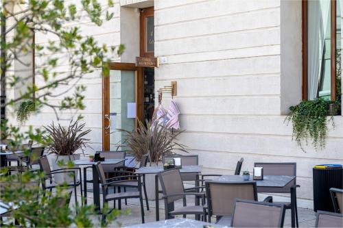 a row of tables and chairs outside a building at Le Camere di Palazzo Bortolan in Treviso