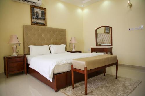 a bedroom with a large bed and a mirror at Park Complex in Salalah