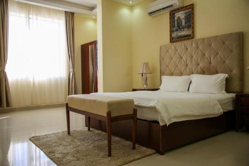 a bedroom with a large bed and a window at Park Complex in Salalah