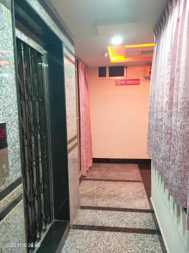 a hallway with a door and a sign that says survival at Hotel New Maruthi Inn, LB Nagar in Hyderabad