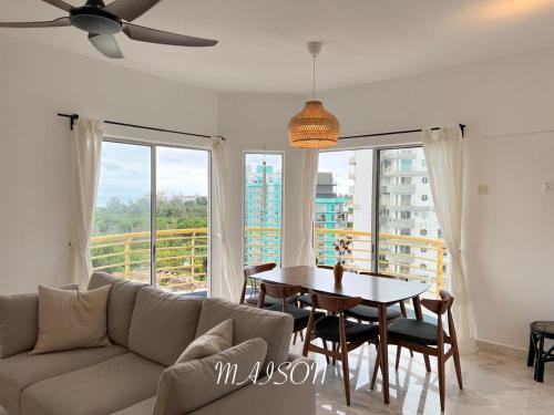 a living room with a couch and a table at BayView Suites Port Dickson By MAISON in Port Dickson