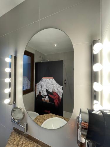 a mirror in a bathroom with a sink at Hotel Paula Films Collection in Merida