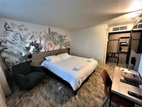 a bedroom with a bed and a chair and a table at HÔTEL KYRIAD MARSEILLE - Vitrolles Aéroport in Vitrolles