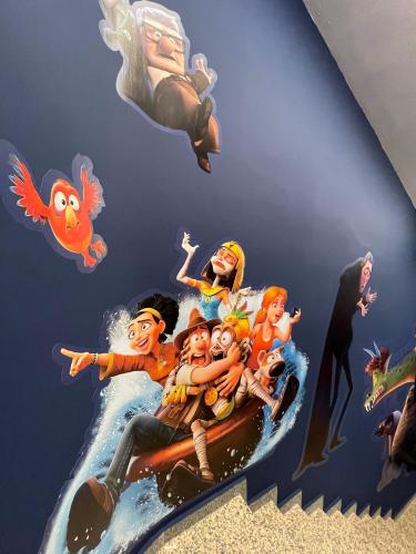 a mural of a group of people riding a wave at Hotel Paula Films Collection in Merida