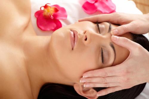 a woman getting her face rejuvenated by a massage therapist at Corallo Wellness Hotel in Diano Marina