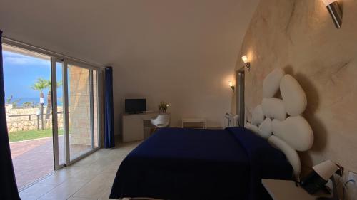 Ένα ή περισσότερα κρεβάτια σε δωμάτιο στο Hotel Capo Campolato
