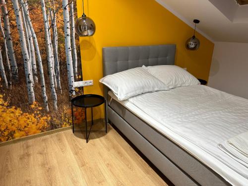 een slaapkamer met een bed en een raam met bomen bij Apartament Nidzica Rzemieślnicza 4 in Nidzica