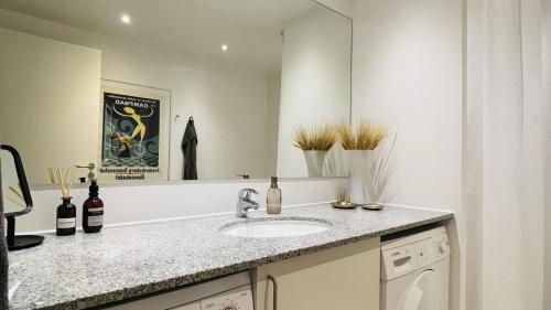 a bathroom with a sink and a mirror at ApartmentInCopenhagen Apartment 1518 in Copenhagen