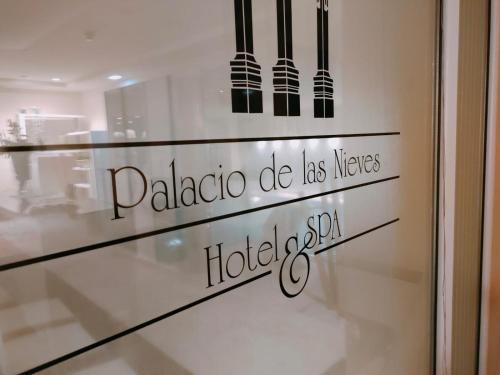 a glass door with the words paladinota do las meters at Hotel Arcea Palacio de las Nieves in Langreo