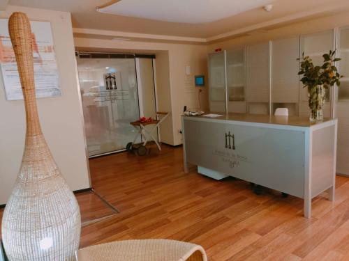 a room with a table and a chair in a room at Hotel Arcea Palacio de las Nieves in Langreo
