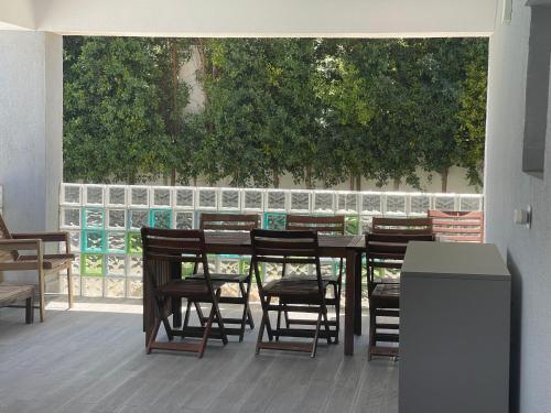 a patio with a table and chairs and a fence at Seaside Place Cascais in Carcavelos