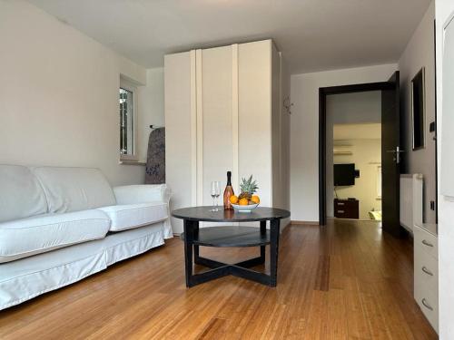 a living room with a white couch and a table at Ribarska Koliba - Stella Adria Villa in Pula