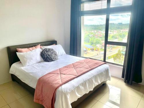 a bedroom with a bed with a large window at SG Residence Deluxe Family Suite Seaview 2Bedroom in Kampong Tanjong