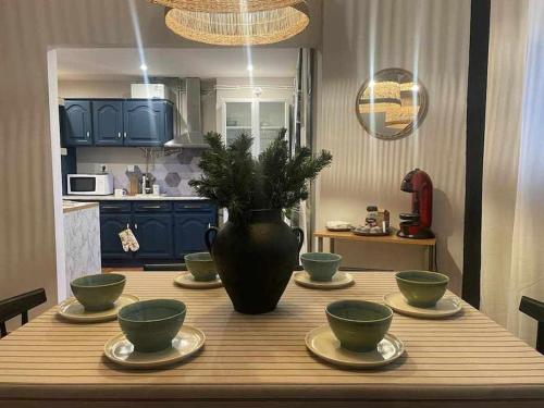 a wooden table with bowls and a vase on top at Apartamento Luxury Mira Espanha na Guarda in Guarda