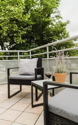 a patio with a table and a chair and a bench at Wohnen auf Zeit in Weingarten in Weingarten
