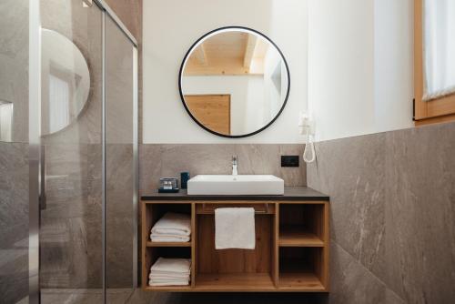 a bathroom with a sink and a mirror at Aria de Munt in San Vigilio Di Marebbe