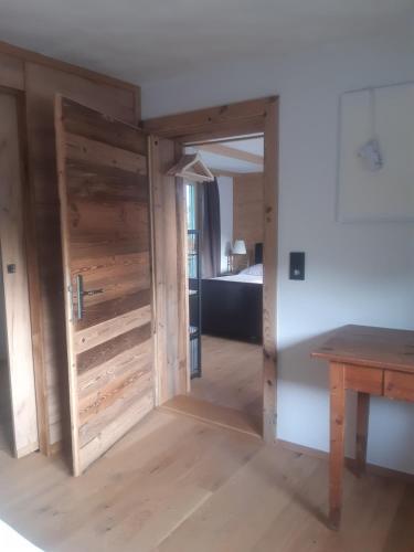 a door leading into a bedroom with a bed at Hüttenzauber in Taxenbach
