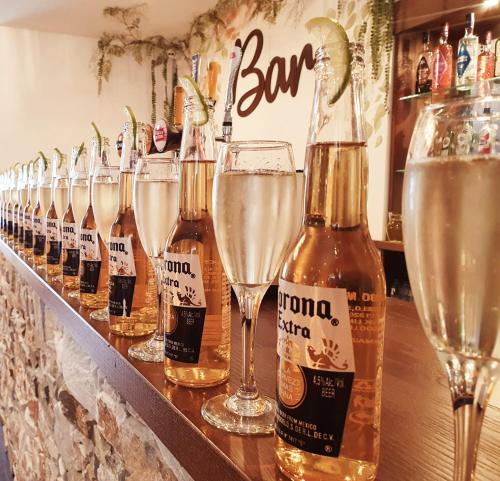 a row of champagne bottles and glasses on a bar at Grains Bar Hotel in Oldham