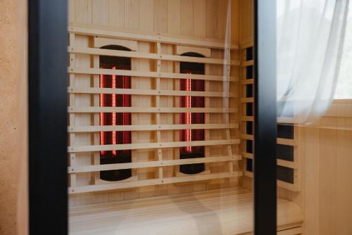 a window with bamboo blinds in a room at Aria de Munt in San Vigilio Di Marebbe
