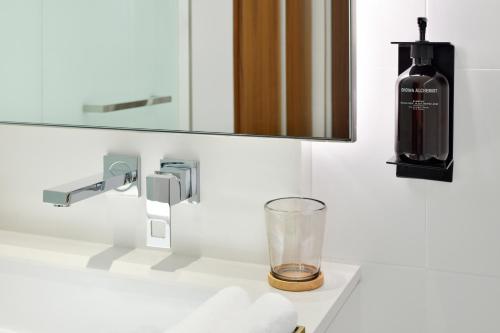 a bathroom with a bottle of wine on a sink at Vida Emirates Hills in Dubai