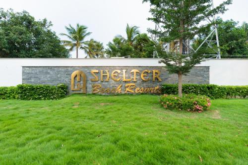 a building with a sign that reads schedler book return at Shelter Beach Resort in Mahabalipuram