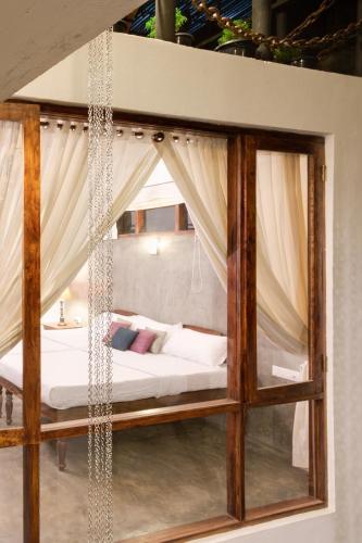 a bedroom with a swinging bed with curtains at Niyati - Boutique Stay in Cochin