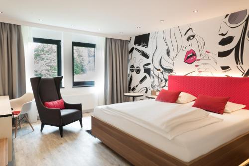 a bedroom with a large bed and a red headboard at Hotel Am Triller - Hotel & Serviced Apartments in Saarbrücken