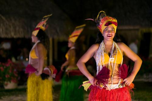 a group of women dressed up in colorful costumes at InterContinental Bora Bora Le Moana Resort by IHG in Bora Bora