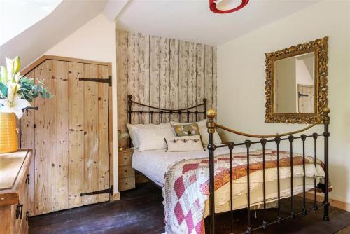 a bedroom with a bed and a mirror at 14th Century Medieval Longhouse 