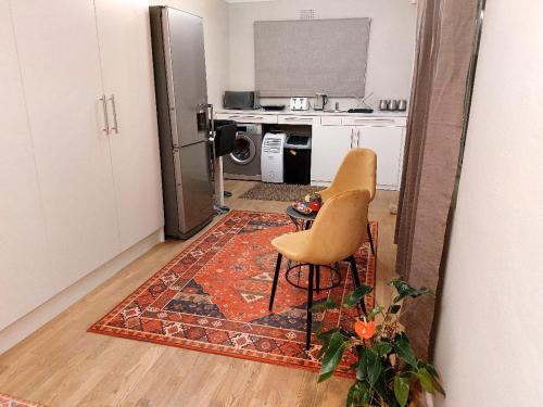 a mirror reflection of a kitchen with a table and a chair at 'Eye 2 SA' with exclusive pool access - Hout Bay in Cape Town