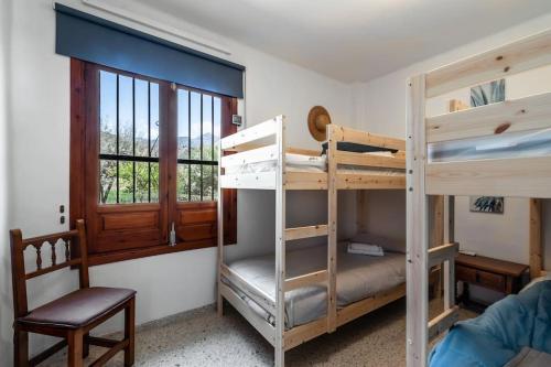 a room with two bunk beds and a chair at Oasis 16 in Nerja