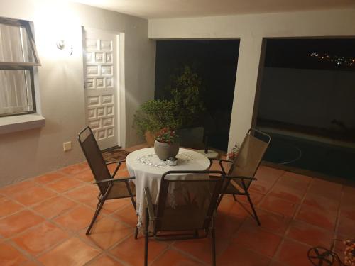 a room with a table and chairs with a plant on it at 'Eye 2 SA' with exclusive pool access - Hout Bay in Cape Town