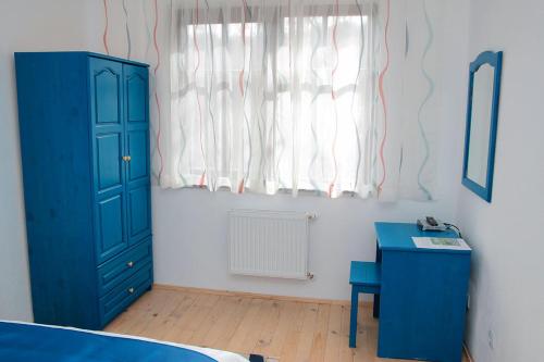 a bedroom with a blue cabinet and a blue desk at Арт комплекс Горски дом - Трявна in Tryavna