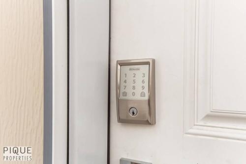 a close up of a door with a remote control at NEW, Euro-Style Suite, Whyte Avenue, AC, Netflix, Sleeps 6! in Edmonton