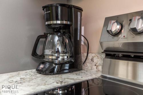 a coffee maker sitting on top of a counter at NEW, Euro-Style Suite, Whyte Avenue, AC, Netflix, Sleeps 6! in Edmonton