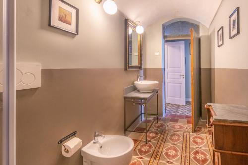 a bathroom with a toilet and a sink at Donna Maddalena in Noto