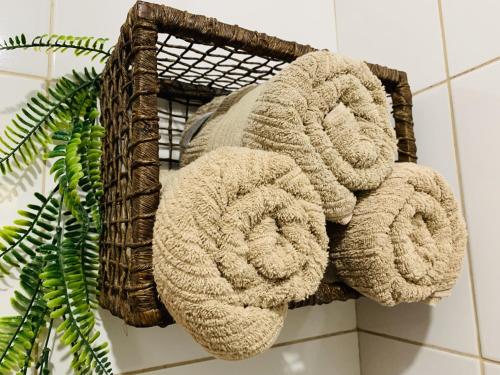 a bunch of towels on a rack in a bathroom at Chalé da cachoeira - Ilhabela in Ilhabela