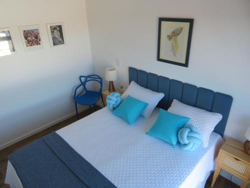 a bedroom with a blue bed with blue pillows at Casa francesa de Piraju in Piraju