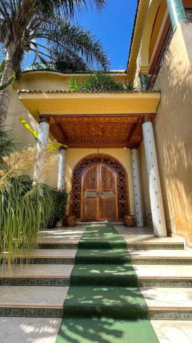 a set of stairs leading to a house with a door at Riad Noumidya in Fès