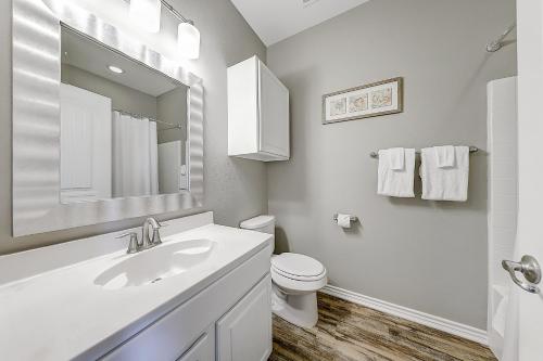 a white bathroom with a sink and a toilet at Beach Way Mermaid Cove in Padre Island
