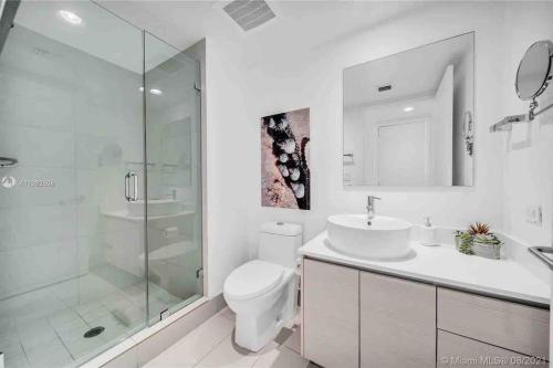 a bathroom with a toilet and a sink and a shower at Relax by the Sea in This Cozy Beachfront Room 908B in Hallandale Beach