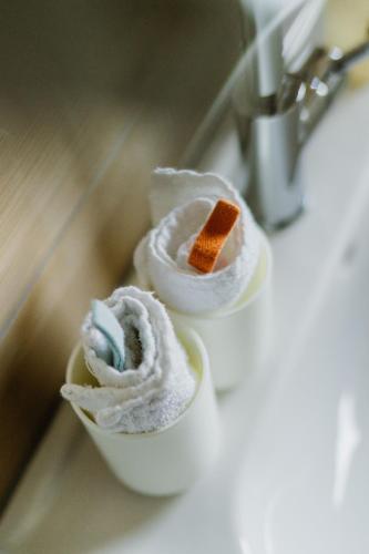 two rolls of toilet paper sitting on a bathroom sink at Wohnen auf Zeit in Weingarten in Weingarten