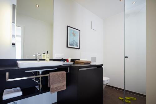 a bathroom with a sink and a toilet at ipartment Frankfurt Europaviertel in Frankfurt