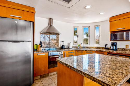 a large kitchen with a stainless steel refrigerator at Nitta 310 PH in Nuevo Vallarta 