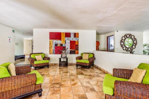 a living room with couches and chairs on a tile floor at Nitta 310 PH in Nuevo Vallarta 