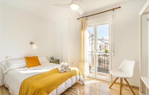 a bedroom with a bed and a chair and a window at Stunning Air Conditioned House in Cijuela