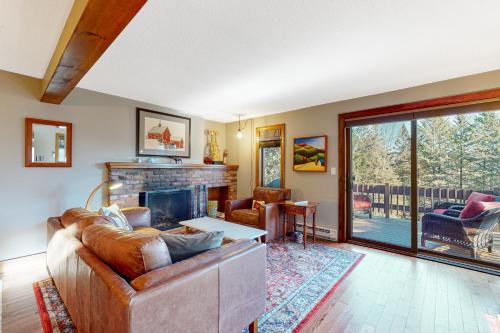 a living room with a couch and a fireplace at Saltbox 2A in Quechee