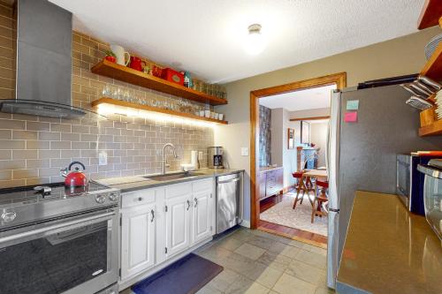 a kitchen with a sink and a refrigerator at Saltbox 2A in Quechee